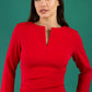model is wearing diva catwalk chandos sheath dress with three quarter sleeve and slit in the middle of the neckline in scarlet red front