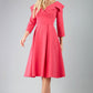model is wearing diva catwalk gatsby swing dress with pocket detail and wide v-neck collar and buttons down the front panel in hibiscus pink front