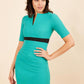 brunette model wearing diva catwalk nadia fitted dress with pencil pleated skirt with sleeves and rounded neckline with split in colour emerald green front