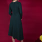 blonde model is wearing diva catwalk dartington asymmetric skirt midaxi long sleeve dress with rounded pleated neckline a-line style in deep green back