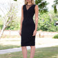 blonde model wearing diva catwalk pastiche pencil fitted sleeveless dress v-neckline with lace overlay in black front