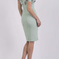Model wearing the Diva Amorette pencil dress with cold shoulder and pleated detailing on the arms in deco green fern back image