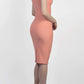 brunette model wearing diva catwalk beyonce pencil fitted dress with high neckline without sleeves with a wide band and pleating across the tummy area with a crossed detail neckline in colour peach back