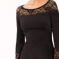 brunette model wearing diva catwalk black lace pencil dress with long sleeves and rounded lace neckline with the lace covering shoulders front