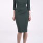 brunette model wearing diva catwalk best selling lydia pencil sleeved dress with slit at the neckline and pleating across the tummy in colour deep green  front