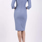 blonde model wearing seed tuscany pencil fitted dress in steel blue colour with a split in the neckline and split detail on sleeves back
