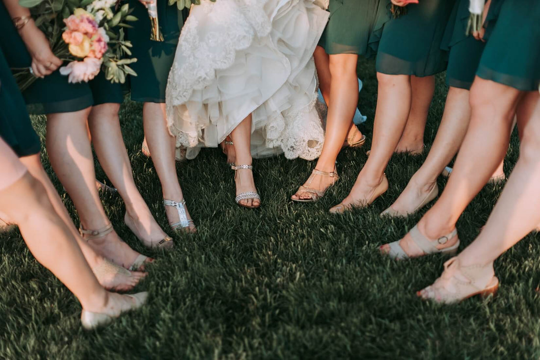 bride and bridesmaids pointing their heels 