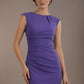 Woman wearing a purple dress against a brown background (Indigo Blue)