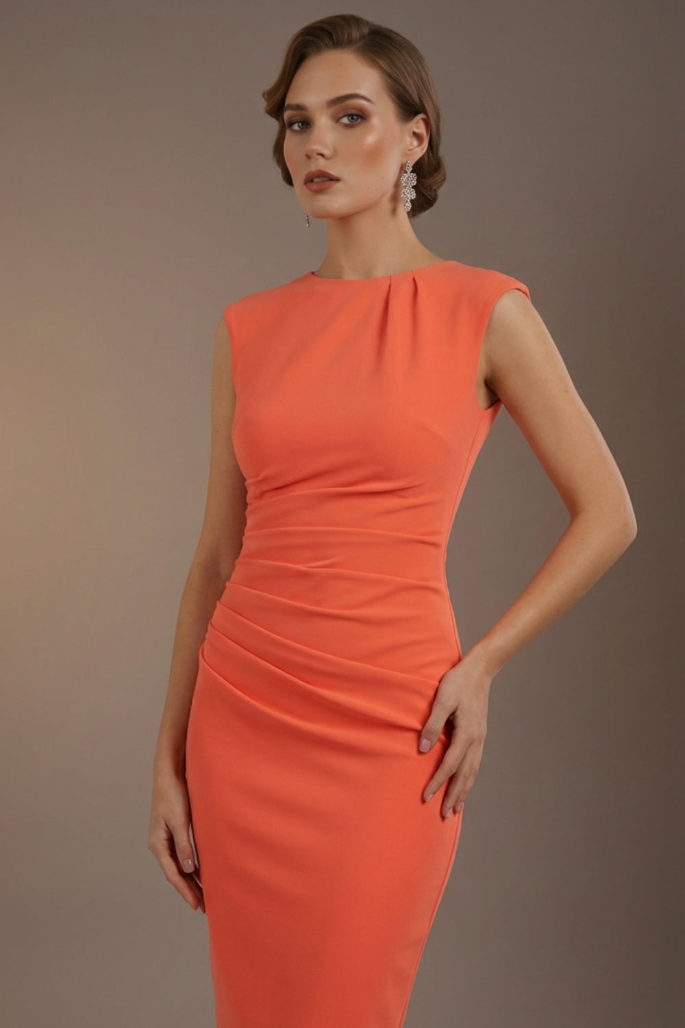 Woman wearing an orange dress against a brown background (Sea Coral)