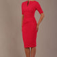 blonde model is wearing diva catwalk lydia short sleeve pencil fitted dress in paradise pink colour with rounded neckline with a slit in the middle front