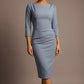 Woman wearing a diva catwalk light blue dress against a brown background - Seed Agatha Sleeved Pencil Dress (Steel Blue)
