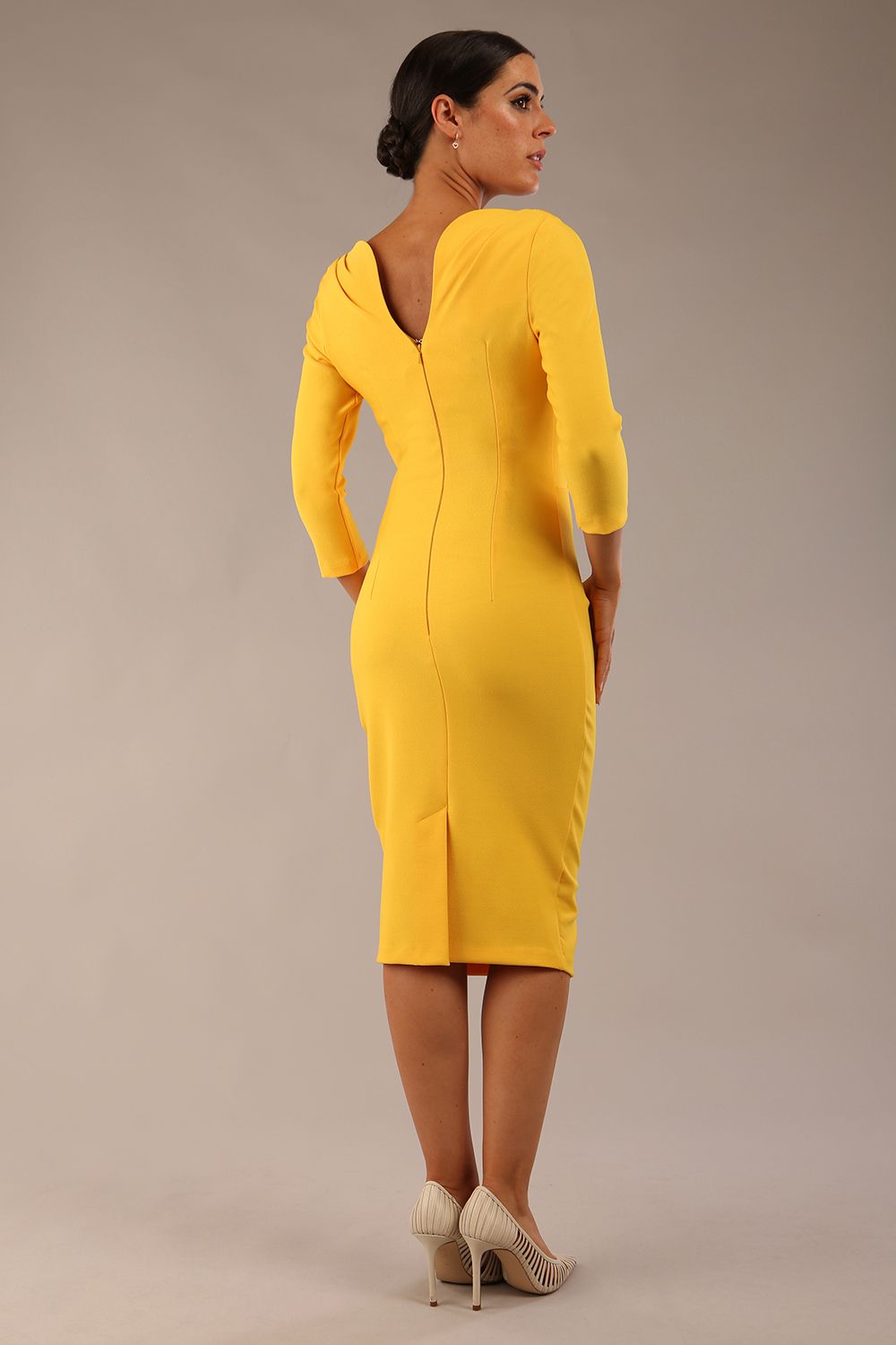 Model wearing the Seed Agatha in pencil dress design in daffodil yellow back image