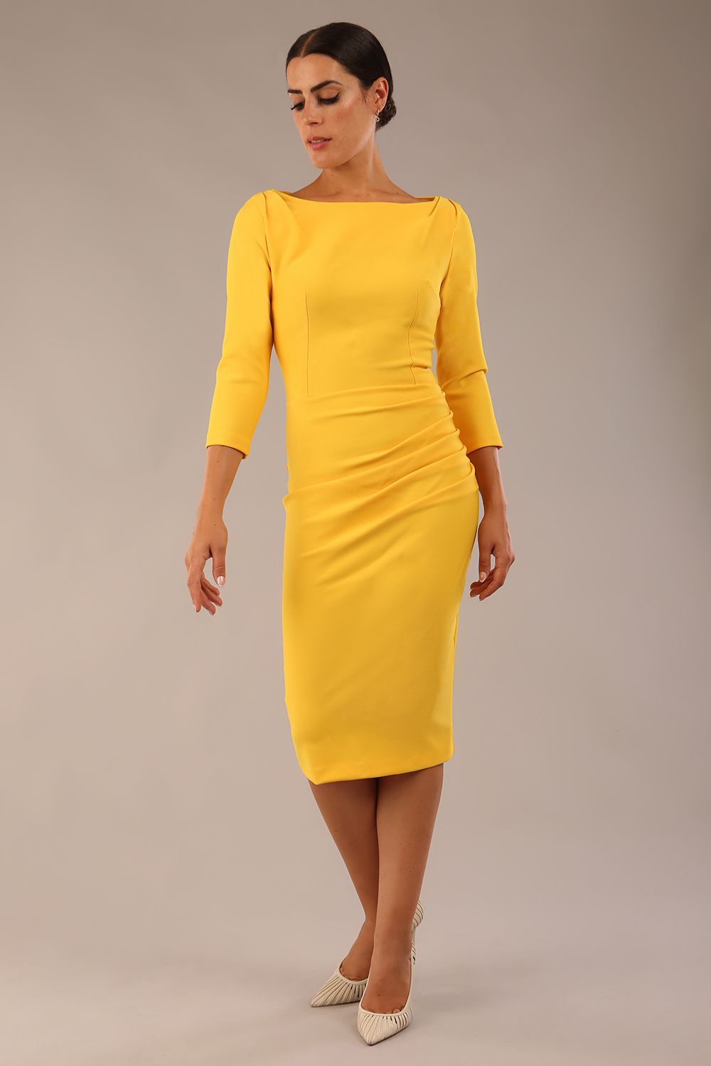 Model wearing the Seed Agatha in pencil dress design in daffodil yellow front image