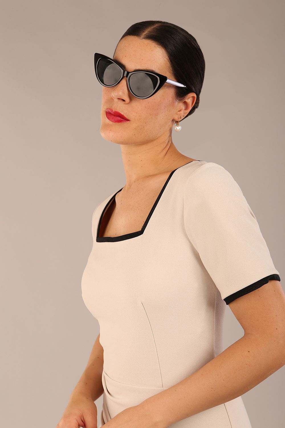 model wearing seed albany contrasted pencil-skirt dress with short sleeves and pleating across the tummy with low square neckline and contrasted detail finishing in sandy cream front