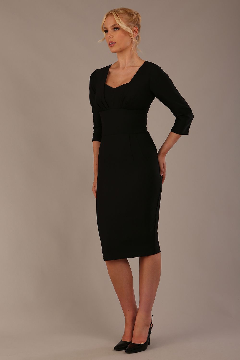 Woman wearing a diva catwalk Seed Greenwich Sleeved Pencil Dress in black colour with a plain background
