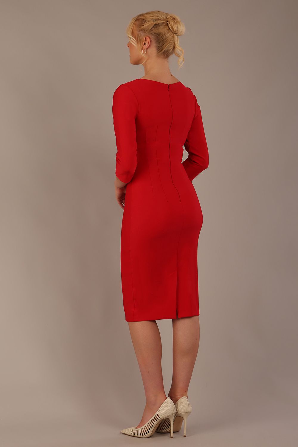 Woman wearing a diva catwalk salsa red Seed Greenwich Sleeved Pencil Dress with a plain background back view