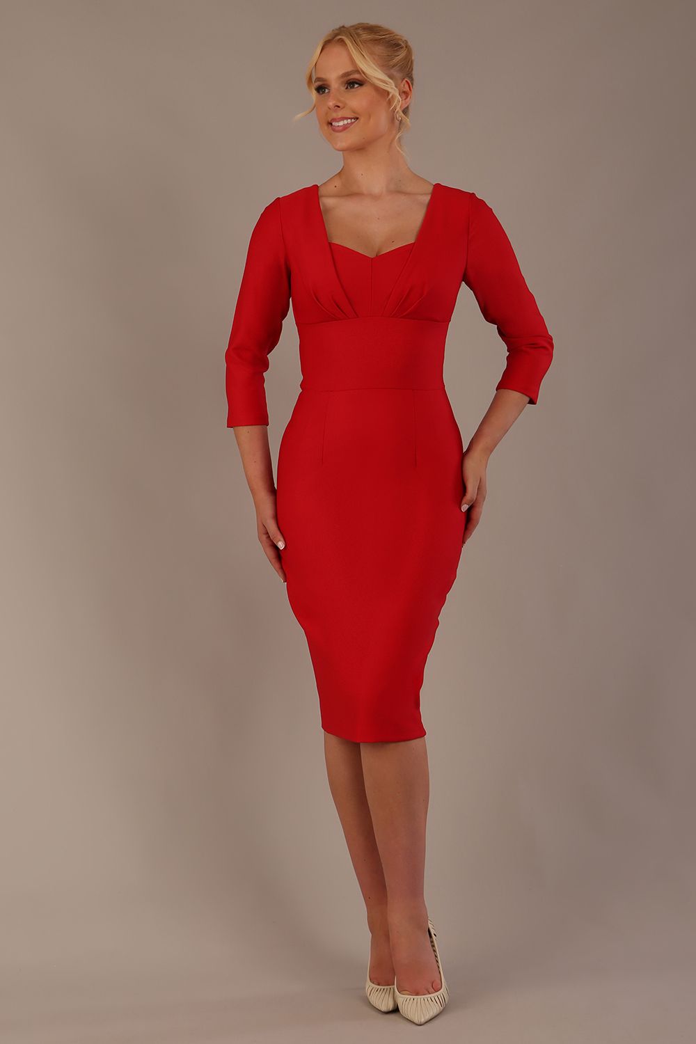 Woman wearing a diva catwalk salsa red Seed Greenwich Sleeved Pencil Dress with a plain background