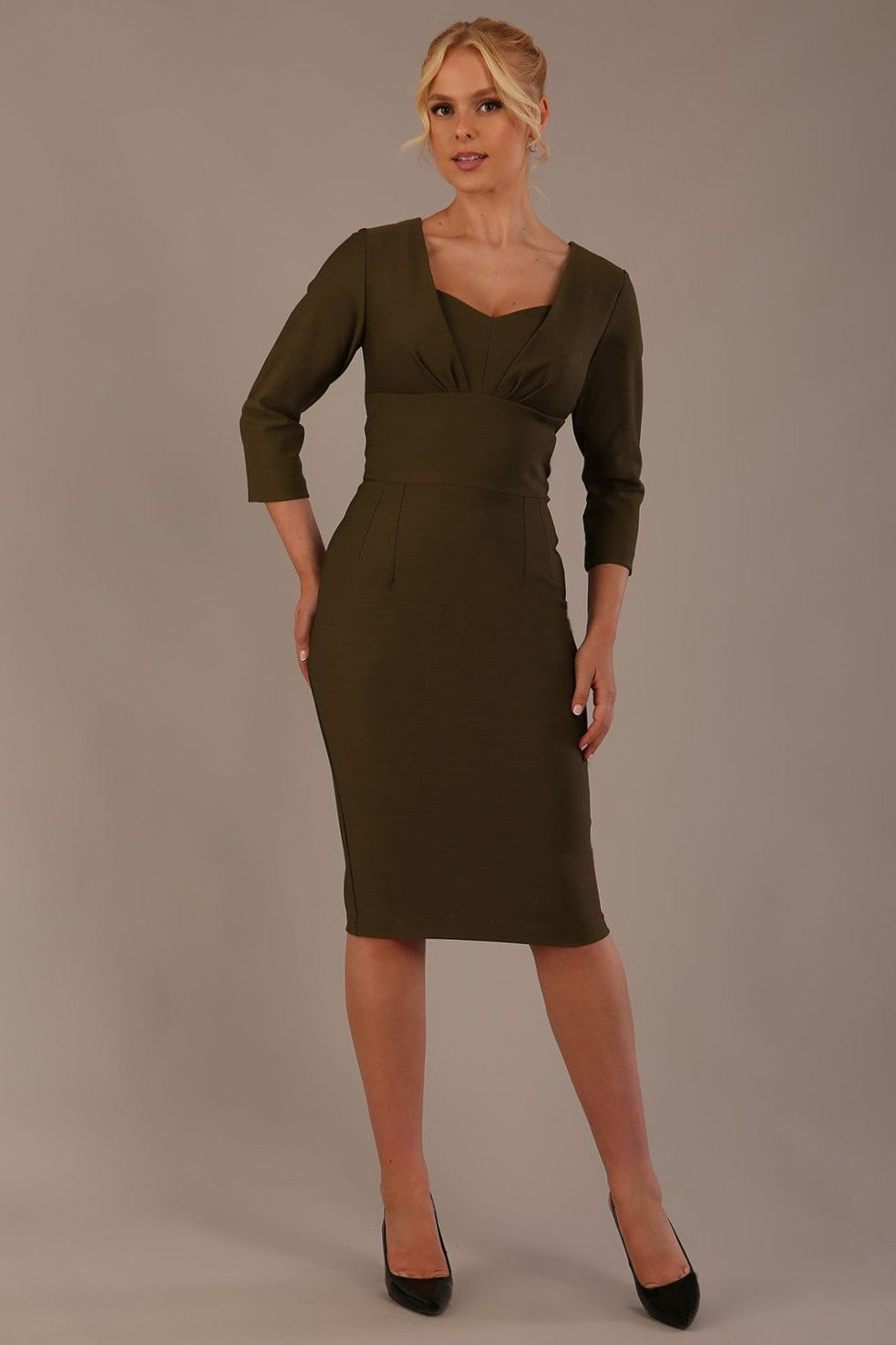 Woman wearing a diva catwalk Seed Greenwich Sleeved Pencil Dress in Olive Green colour with a plain background