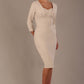 Woman wearing a diva catwalk Seed Greenwich Sleeved Pencil Dress in sandy cream colour with a plain background