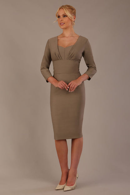 Woman wearing a diva catwalk Seed Greenwich Sleeved Pencil Dress in taupe brown colour with a plain 