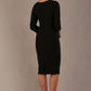 Woman wearing a diva catwalk Seed Greenwich Sleeved Pencil Dress in black colour with a plain background back view