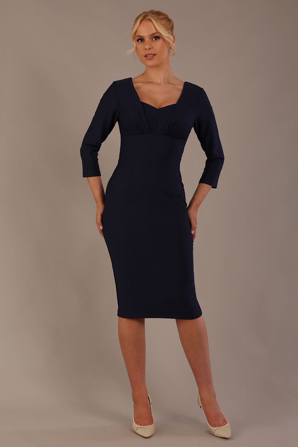 Woman wearing a diva catwalk Seed Greenwich Sleeved Pencil Dress in navy blue colour with a plain background