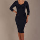 Woman wearing a diva catwalk Seed Greenwich Sleeved Pencil Dress in navy blue colour with a plain background