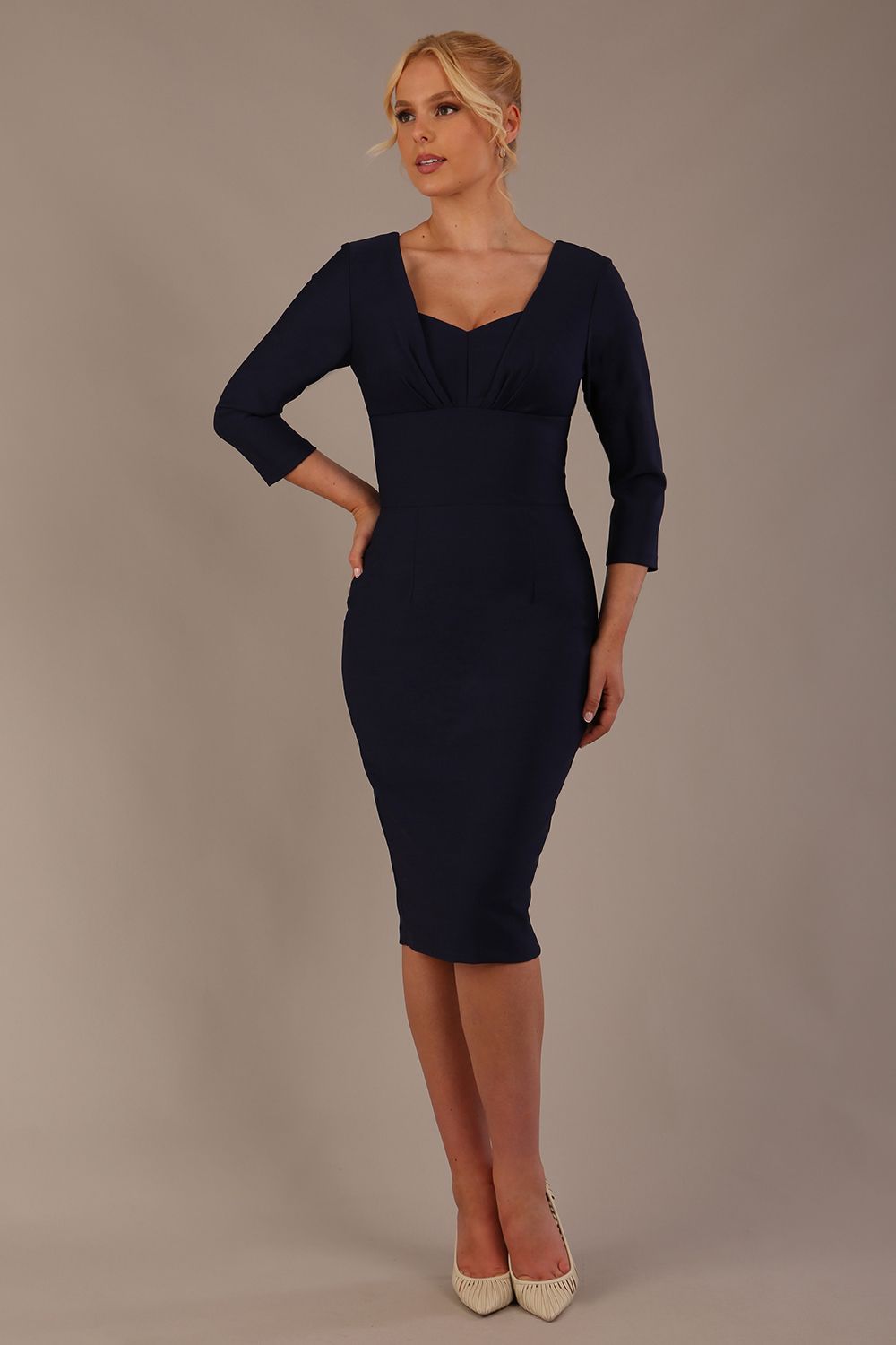Woman wearing a diva catwalk Seed Greenwich Sleeved Pencil Dress in navy blue colour with a plain background