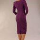 model is wearing a diva catwalk seed fitzrovia 3/4 sleeve pencil dress with round neckline and v-slit and pleating details on the skirt in Royal Purple back