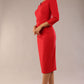 model is wearing a diva catwalk seed fitzrovia 3/4 sleeve pencil dress with round neckline and v-slit and pleating details on the skirt in salsa red side front