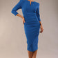 model is wearing a diva catwalk seed fitzrovia 3/4 sleeve pencil dress with round neckline and v-slit and pleating details on the skirt in sapphire blue front