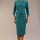 model is wearing a diva catwalk seed fitzrovia 3/4 sleeve pencil dress with round neckline and v-slit and pleating details on the skirt in harbour green front