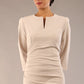 model is wearing a diva catwalk seed fitzrovia 3/4 sleeve pencil dress with round neckline and v-slit and pleating details on the skirt in sandy cream front