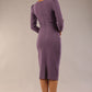 model is wearing a diva catwalk seed fitzrovia 3/4 sleeve pencil dress with round neckline and v-slit and pleating details on the skirt in dusky lilac back