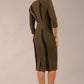 model wearing seed bertie dress with sleeves and rounded neckline with lace details pointing towards the band in olive green back