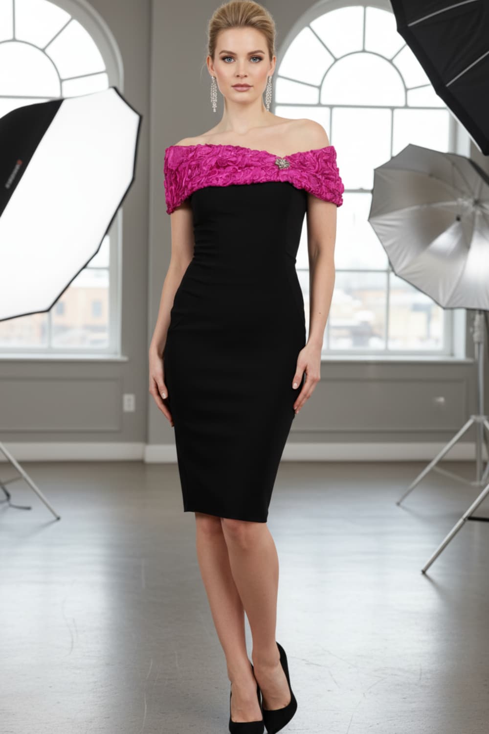 Model wearing the Diva Cornelli Perth dress with cornelli lace top, off shoulder design and diamanté brooch in black and fushia pink front image (Black & Fuchsia)