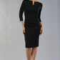 model wearing diva catwalk donna pencil dress with wide band and sleeves and rounded neckline with low split in black colour front