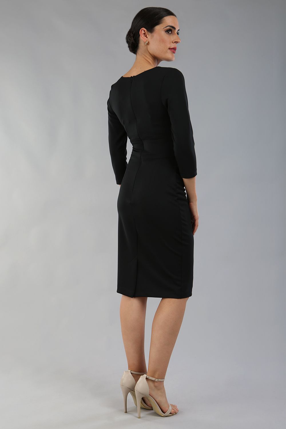 model wearing diva catwalk donna pencil dress with wide band and sleeves and rounded neckline with low split in black colour back 