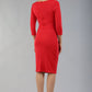 model wearing diva catwalk donna pencil dress with wide band and sleeves and rounded neckline with low split in electric red colour back