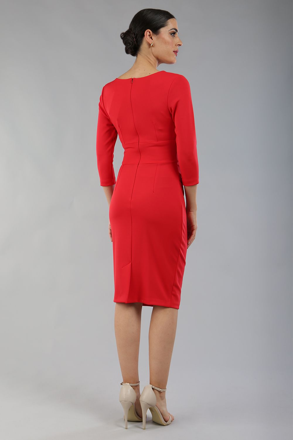 model wearing diva catwalk donna pencil dress with wide band and sleeves and rounded neckline with low split in electric red colour back