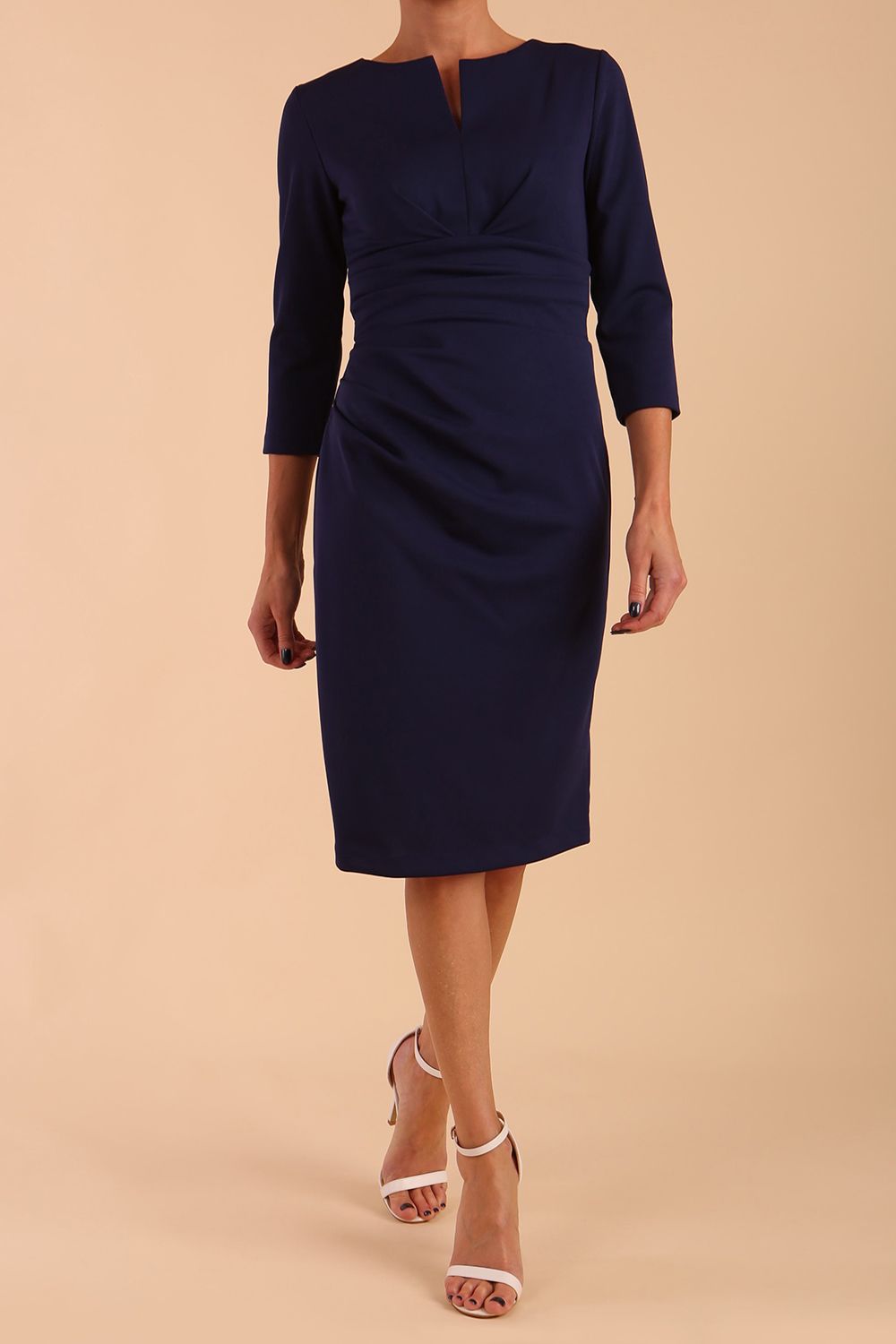 model wearing diva catwalk donna pencil dress with wide band and sleeves and rounded neckline with low split in navy blue colour front