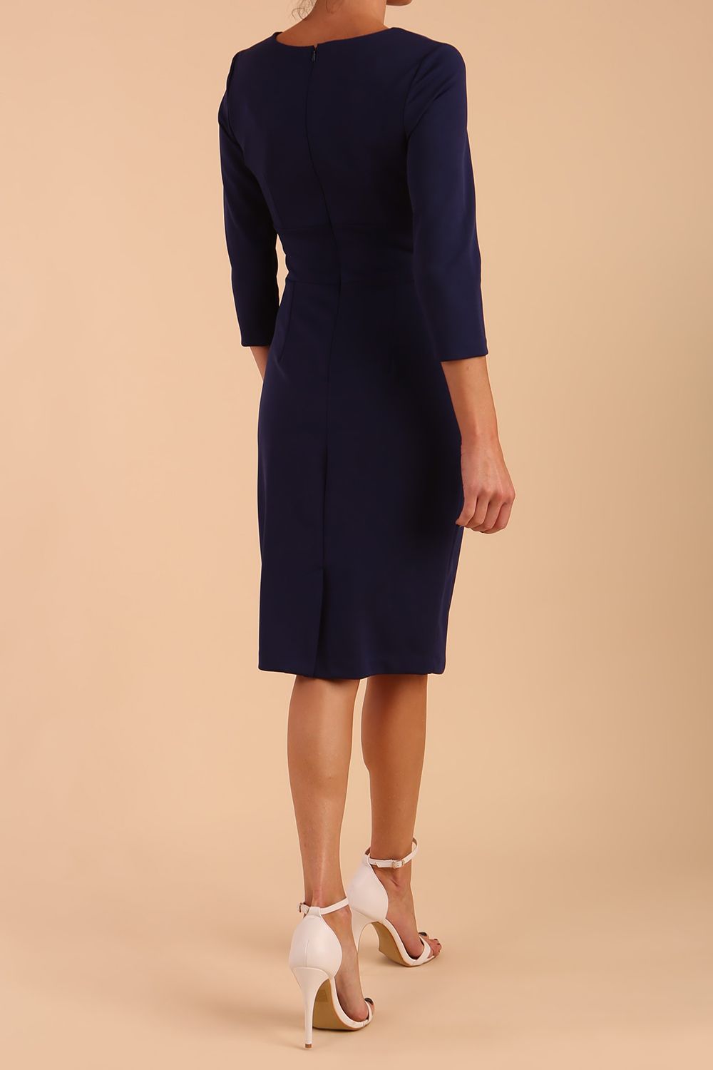 model wearing diva catwalk donna pencil dress with wide band and sleeves and rounded neckline with low split in navy blue colour back