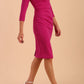 model wearing diva catwalk donna pencil dress with wide band and sleeves and rounded neckline with low split in Magenta colour front side