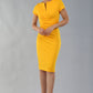 Model wearing Diva Catwalk Donna Short Sleeve Pencil Dress with a wide band and pleating across the tummy area in Saffron Yellow  front