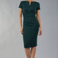 Model wearing Diva Catwalk Donna Short Sleeve Pencil Dress with a wide band and pleating across the tummy area in Forest Green  front