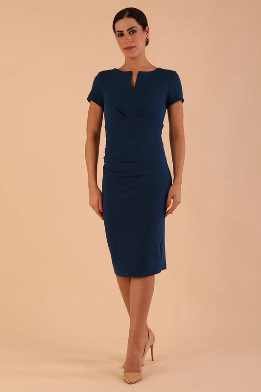 model wearing diva catwalk donna pencil dress in colour glorious teal with wide band and sleeves and rounded neckline with low split in front