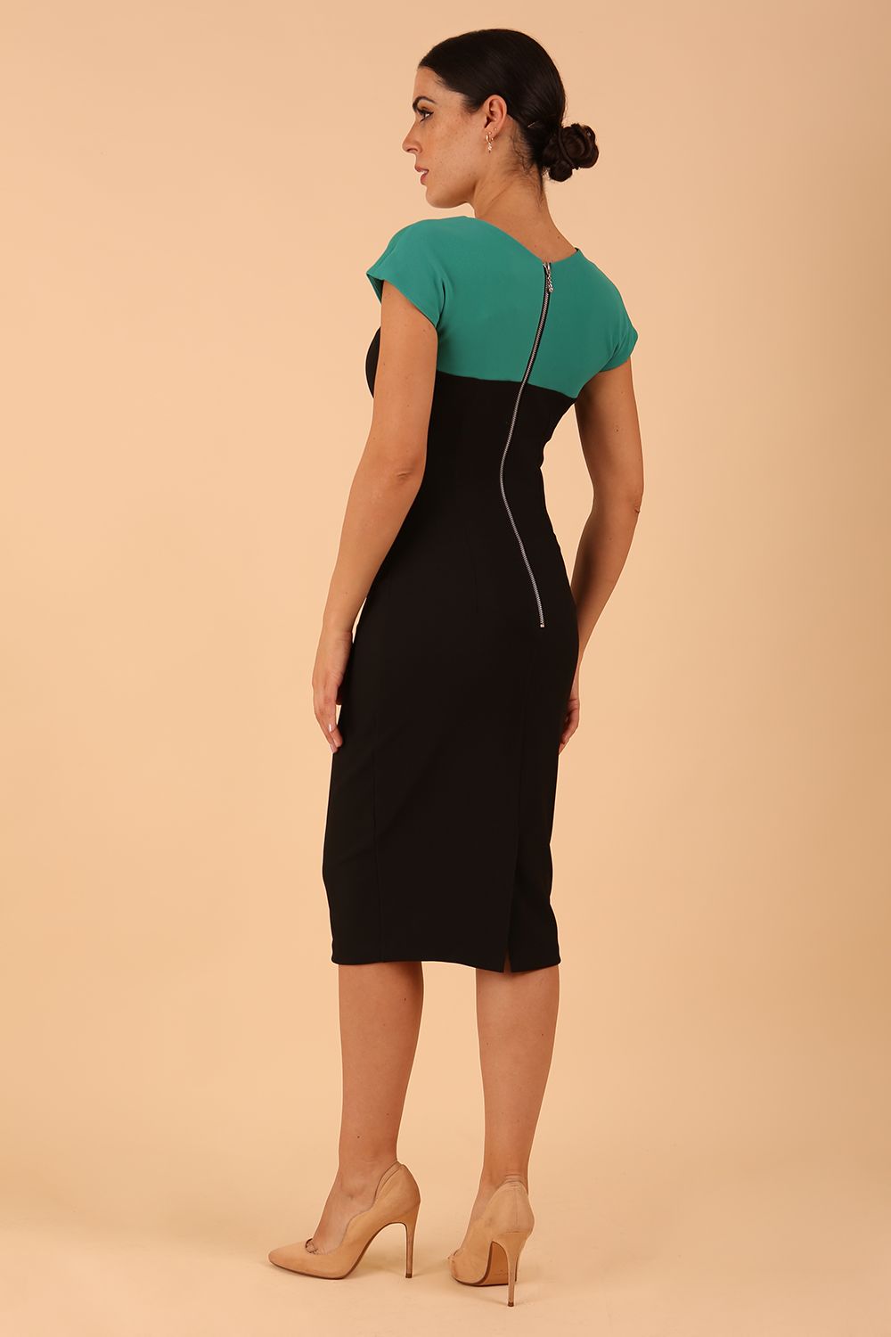 Model wearing the Diva Bryony Contrast dress with contrasting top and exposed zip at the back in black and emerald green back image