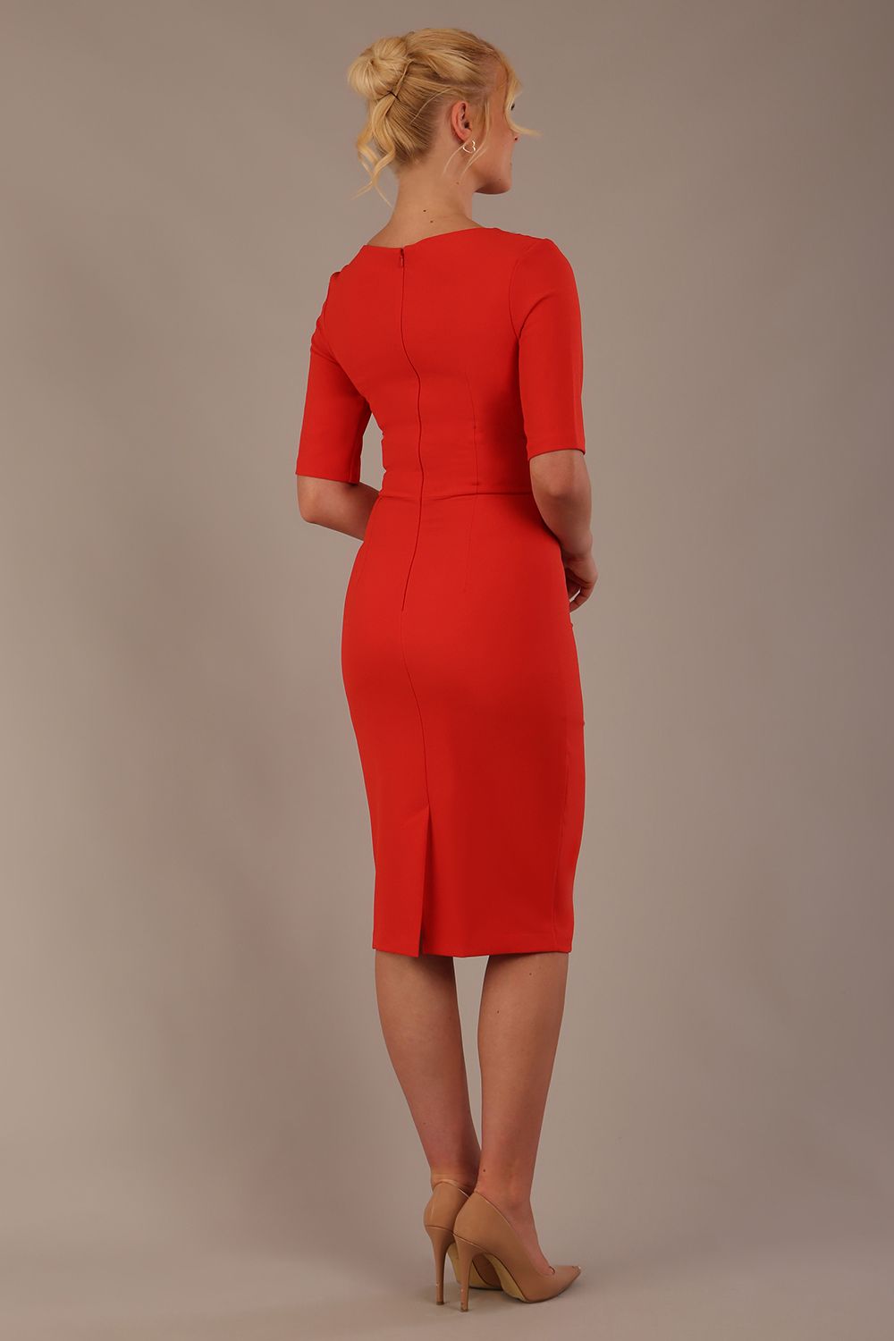 Model wearing the Diva Lynette dress in pencil dress design in fiesta orange front image back view