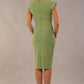 model wearing diva catwalk daphne sleeveless aspen green pencil dress with rounded neckline with split in the middle 