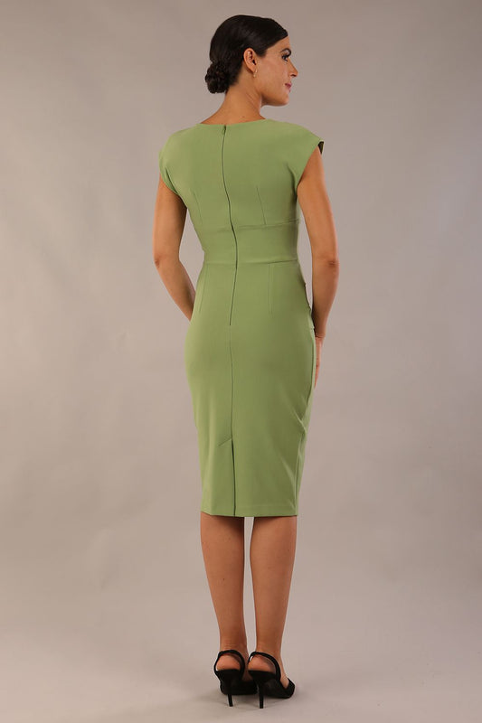 model wearing diva catwalk daphne sleeveless aspen green pencil dress with rounded neckline with split in the middle 